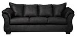 Full indoor shot of a black three-seat sofa. The sofa is a dark, solid black color. It features gently curved armrests and a slightly raised back, characteristic of a contemporary style. The cushions appear to be filled and are upholstered in the same material as the rest of the sofa. The sofa's lines are smooth and the overall impression is of a comfortable and modern piece of furniture. The sofa sits on four, visible, slightly angled, dark brown/black legs. The background is pure white, isolating the sofa as the central focus.