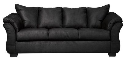 Full indoor shot of a black three-seat sofa. The sofa is a dark, solid black color. It features gently curved armrests and a slightly raised back, characteristic of a contemporary style. The cushions appear to be filled and are upholstered in the same material as the rest of the sofa. The sofa's lines are smooth and the overall impression is of a comfortable and modern piece of furniture. The sofa sits on four, visible, slightly angled, dark brown/black legs. The background is pure white, isolating the sofa as the central focus.