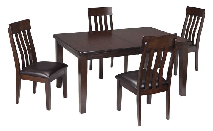 A dark wood dining table set with four matching chairs, each with vertical slat backs and cushioned seats, arranged around the table.