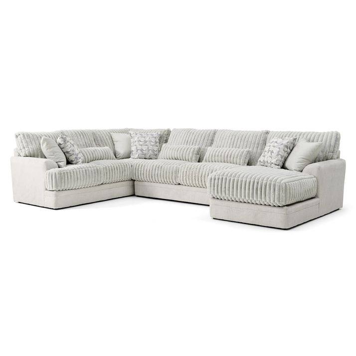 A modern, U-shaped sectional sofa in a light gray fabric with a ribbed texture is displayed against a plain white background. The sofa features a chaise lounge on the right side and plush, cushioned seating with a deep, comfortable design. It is adorned with several decorative pillows, including rectangular and square shapes, some with subtle white and gray patterned designs. The overall style is contemporary and cozy, suitable for a living room setting.