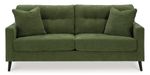 A dark olive green sofa is centrally positioned against a plain white background.   The sofa has a classic, padded, button-tufted back, and the upholstery has a subtle, textured weave. Two matching armrests are visible on each side. The sofa's legs are a dark brown or black wood tone. Two square accent pillows are placed on the back of the sofa. The couch appears to be modern and well-made.