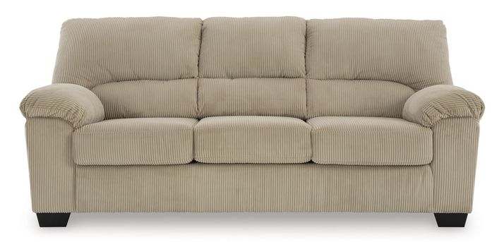 Full shot of a light beige or cream-colored three-seater sofa. The sofa has a corduroy-like textured fabric, with subtle vertical ribbed lines. The upholstery is a consistent tone. The sofa's arms are slightly flared and rounded, with a slightly tufted or quilted effect on the back and seat cushions. It has a classic, simple design with no embellishments. The sofa's legs are a dark, slightly brownish black color and are of a contemporary, slightly tapered design. The sofa is presented against a pure white background, which allows the color and details of the sofa to stand out clearly.