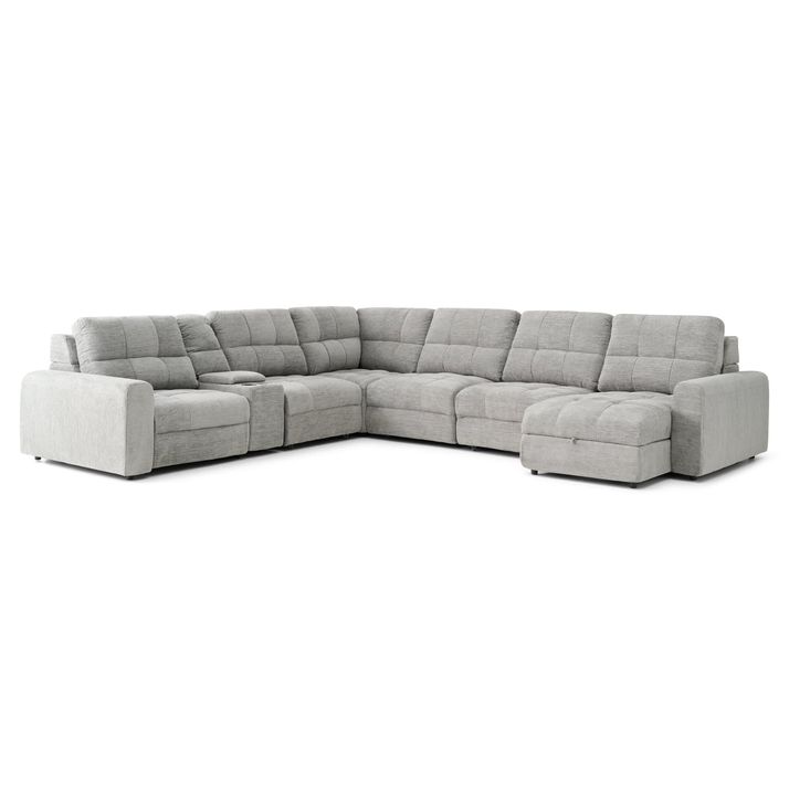 A light gray, sectional sofa is centered against a plain white background.    The sofa is an L-shape with a chaise lounge section extending from the main seating area. The upholstery appears to be a textured fabric with a subtle quilted pattern.  Each end of the sofa has padded armrests. A small, recessed storage space is visible in a section of the sofa.    The sofa is presented in a way that showcases its shape and style, and the soft light gray color makes it stand out.