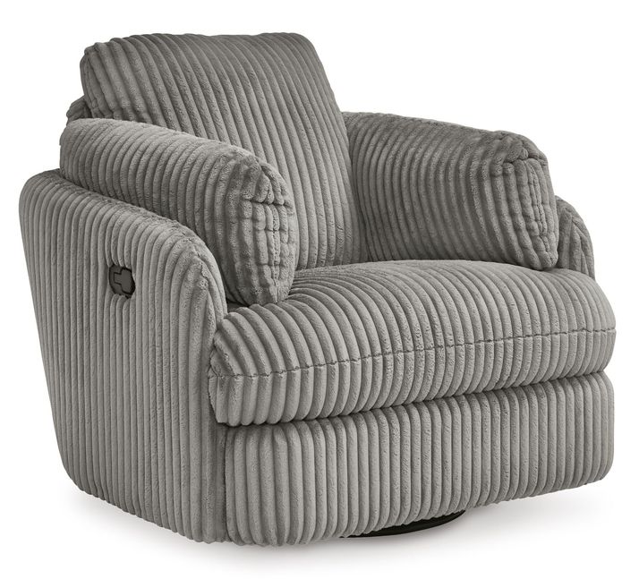 A cozy, modern armchair with a plush, ribbed fabric upholstery in a soft gray color. The chair features a wide, cushioned seat and backrest, with thick, padded armrests that curve gently outward for added comfort. The chair sits on a circular base, allowing it to swivel, and is set against a plain white background, highlighting its luxurious texture and contemporary style.