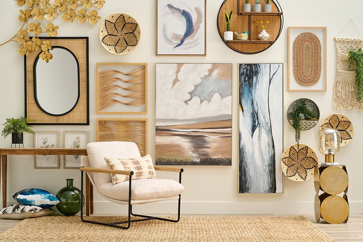 A stylish living room corner features a gallery wall with eclectic art, natural textures, and cozy furniture in a modern boho design.
